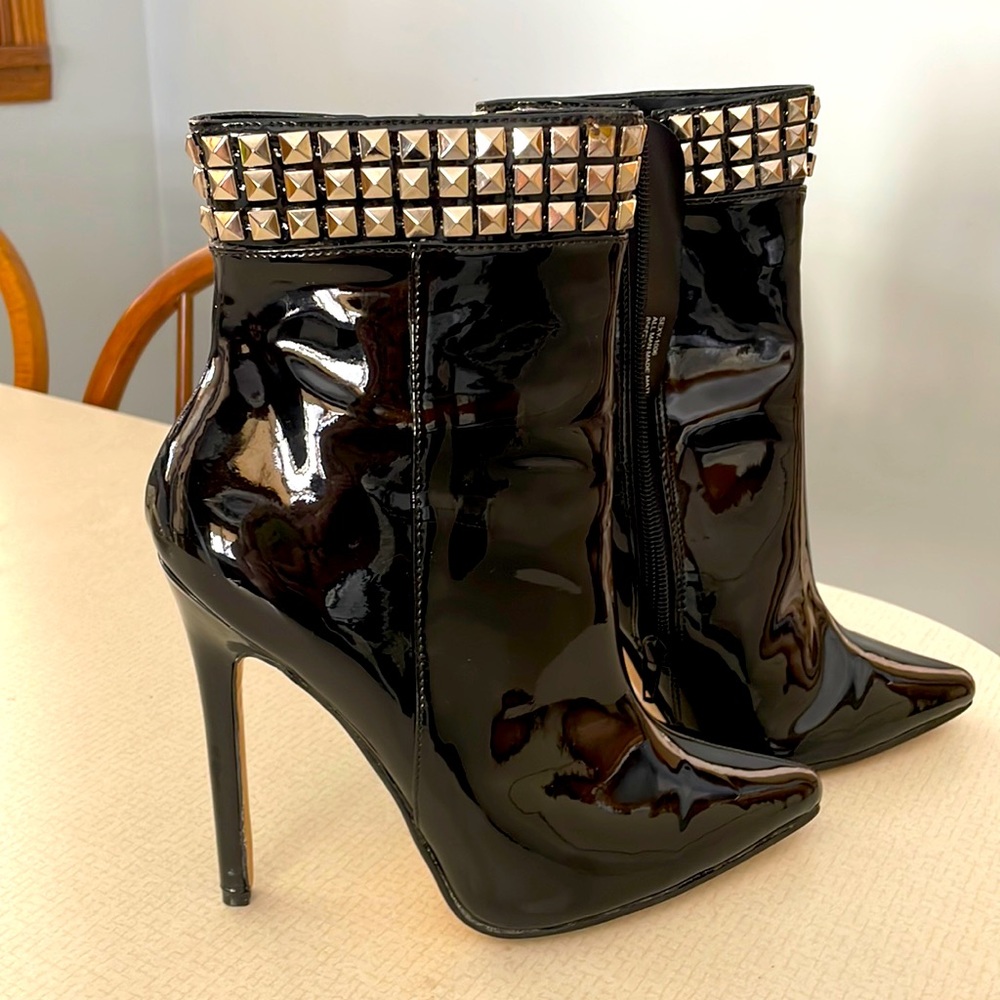 Black shinny heel ankle boots with studs.
